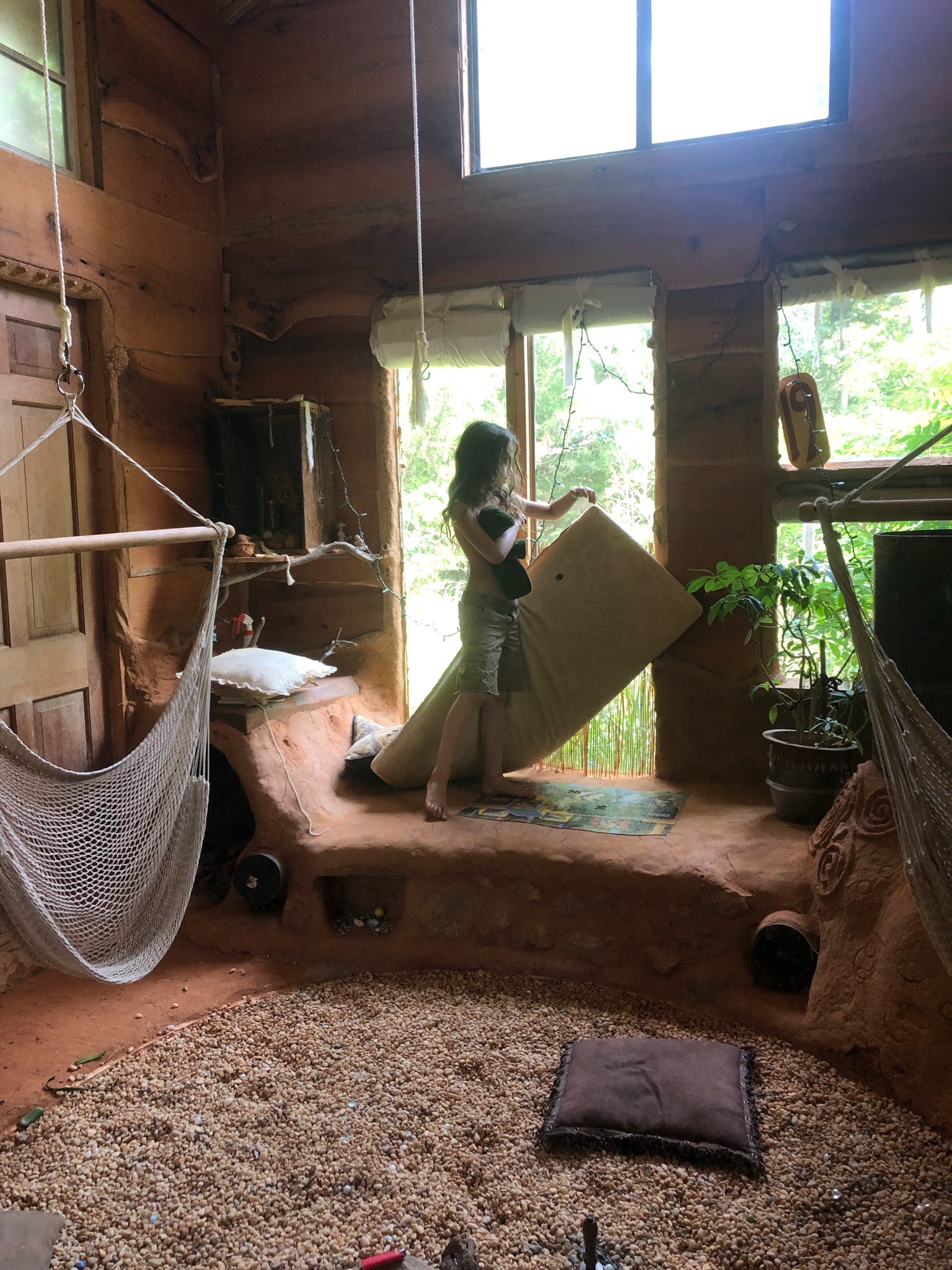 Child picking up a retangular shaped thing in a cool room.
